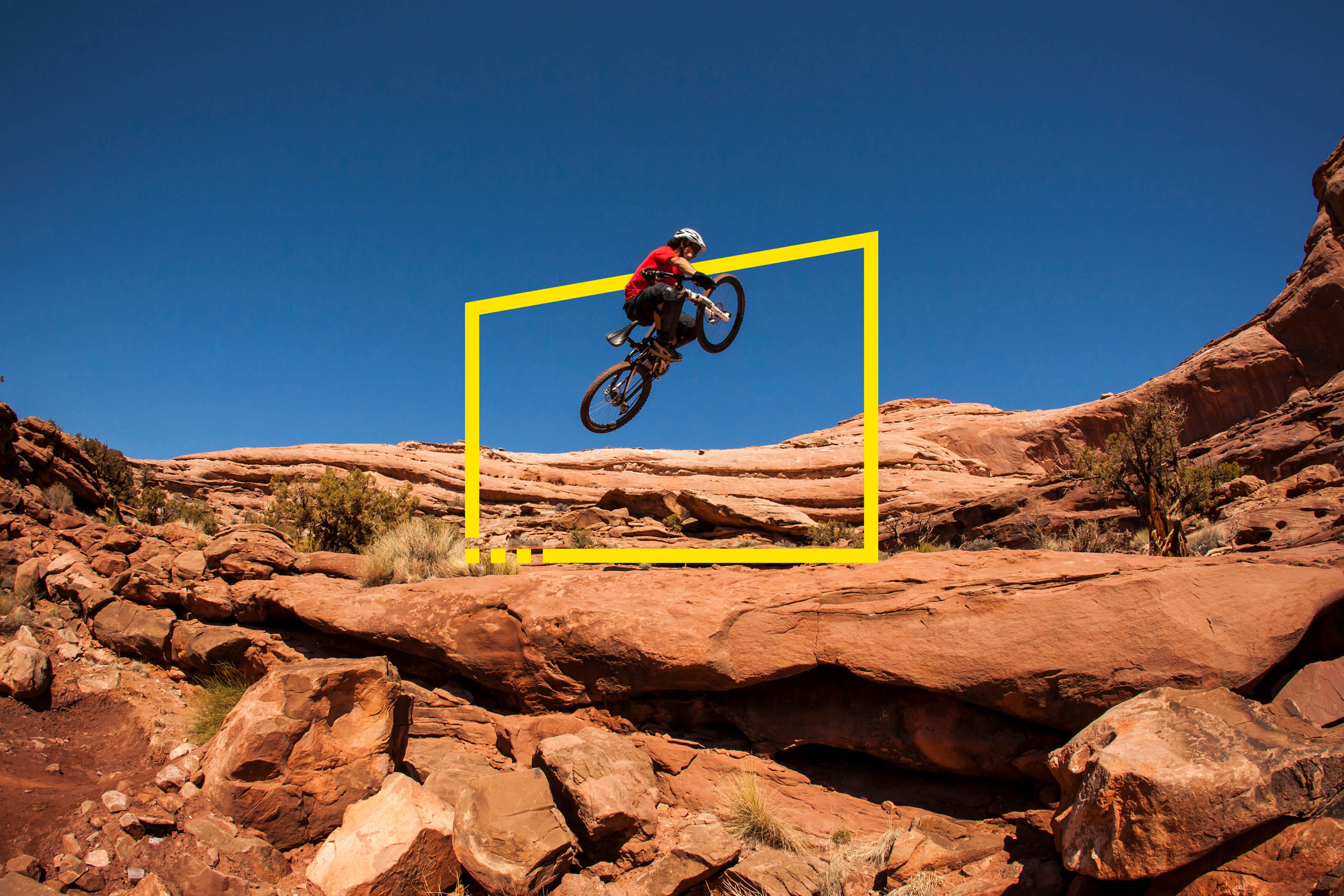 A man getting air on a jump on his mountain bike near moab utah