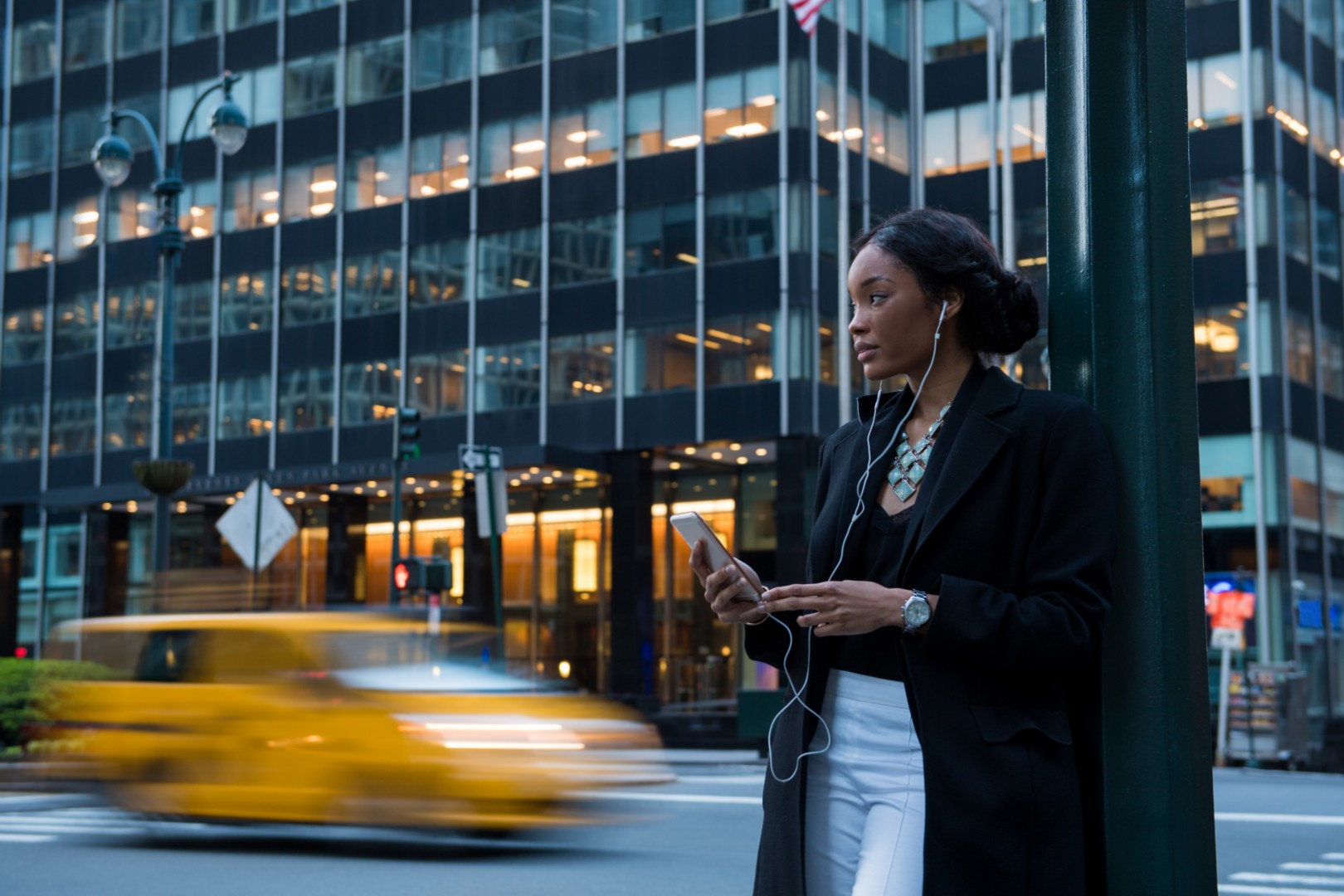 Woman using her mobile while wearing headphones