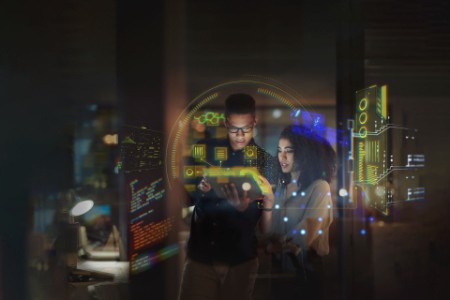 business colleagues reviewing data in office at night