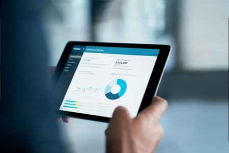 Businessman analyzing statistics on a digital tablet