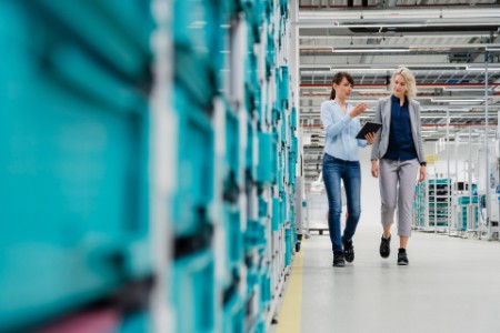 Businesswoman discussing with coworker at electrical industry