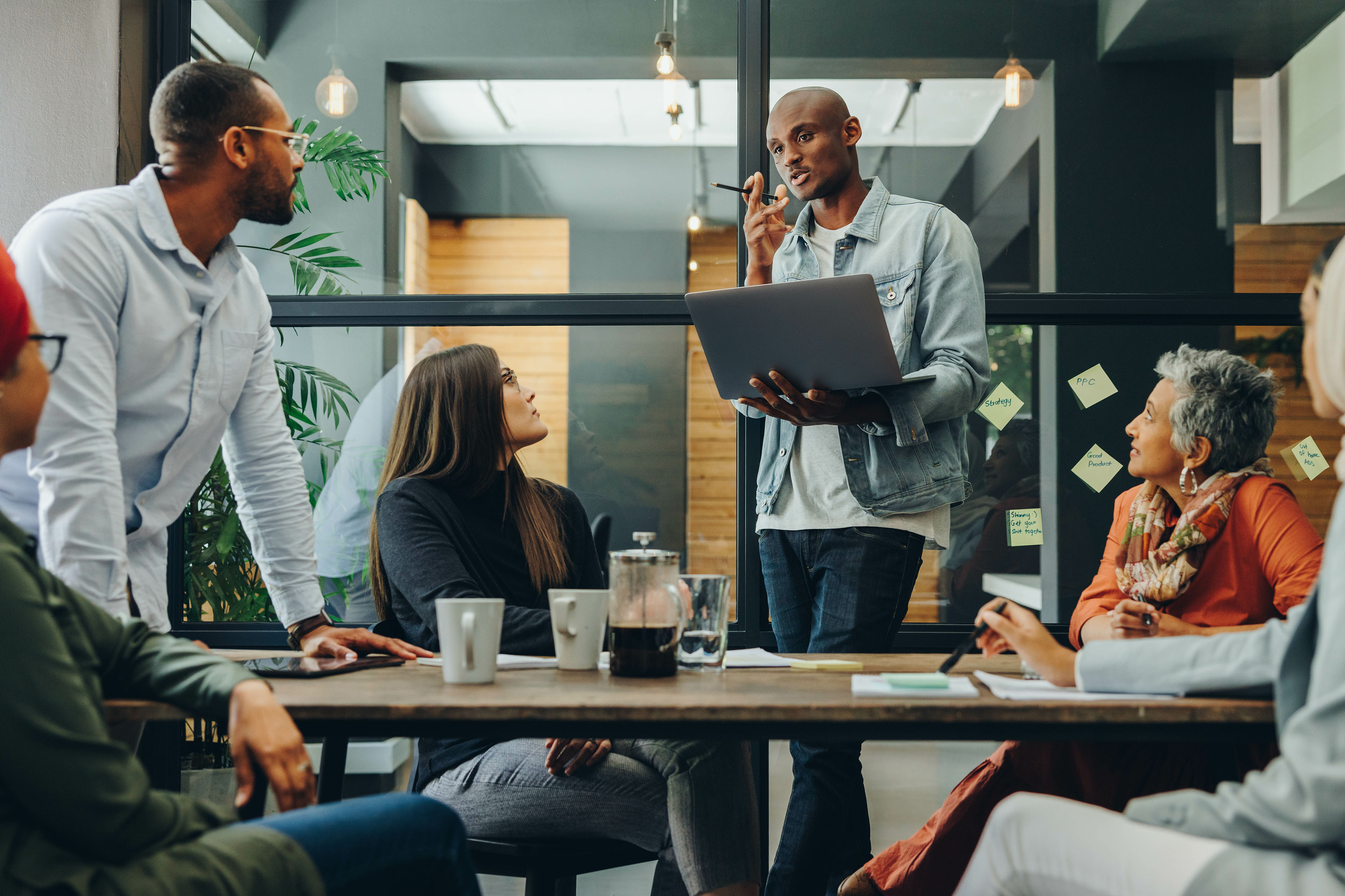 Diverse business team having a meeting in a creative workplace Diverse business team having a meeting in a creative workplace