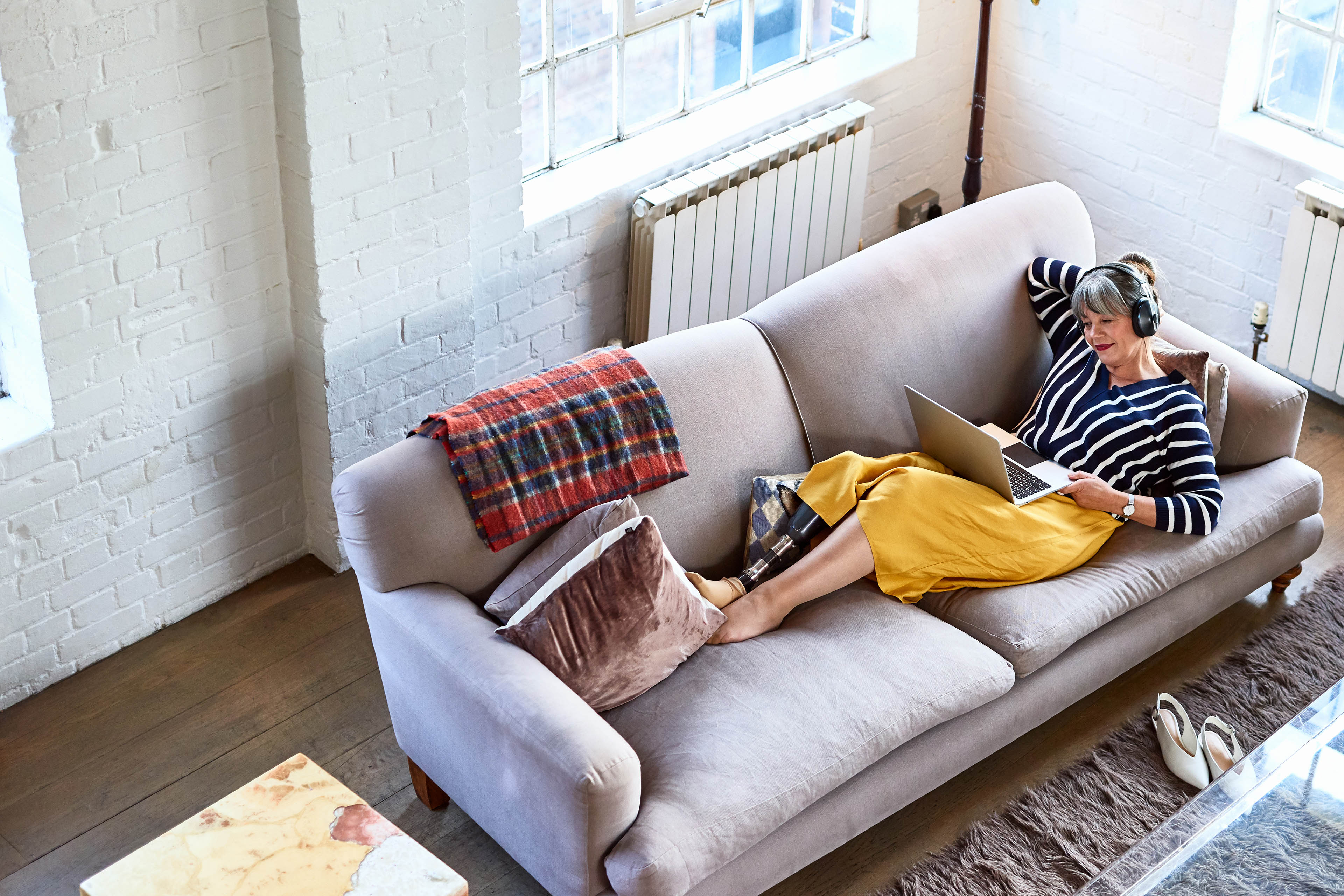 High angle view of woman on sofa with laptop Child walking on footpath