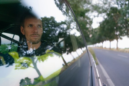 Man in protective workwear in a car