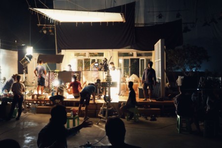 Silhouette of people working in big production studio