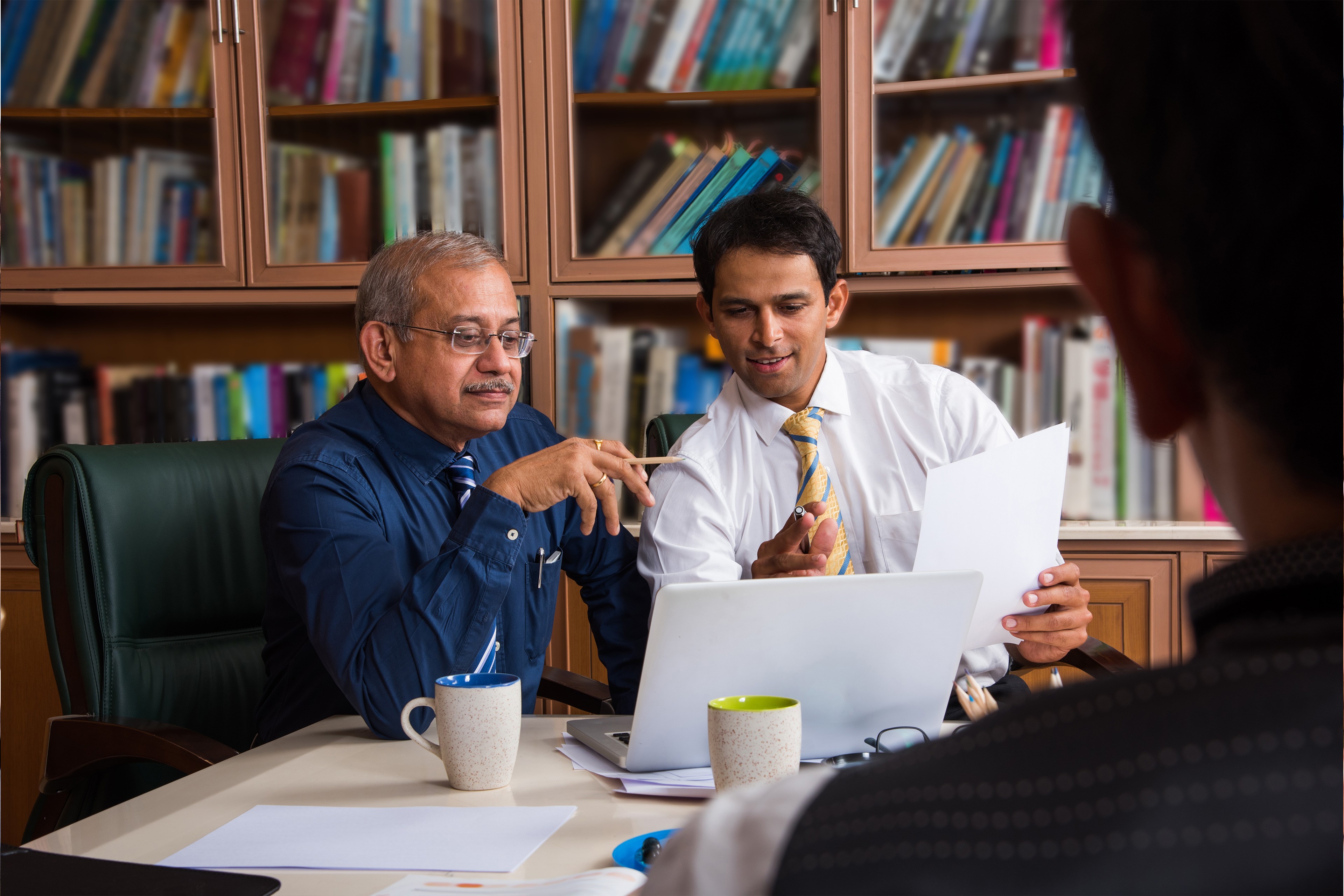 Two business men looking at computer Two business men looking at computer