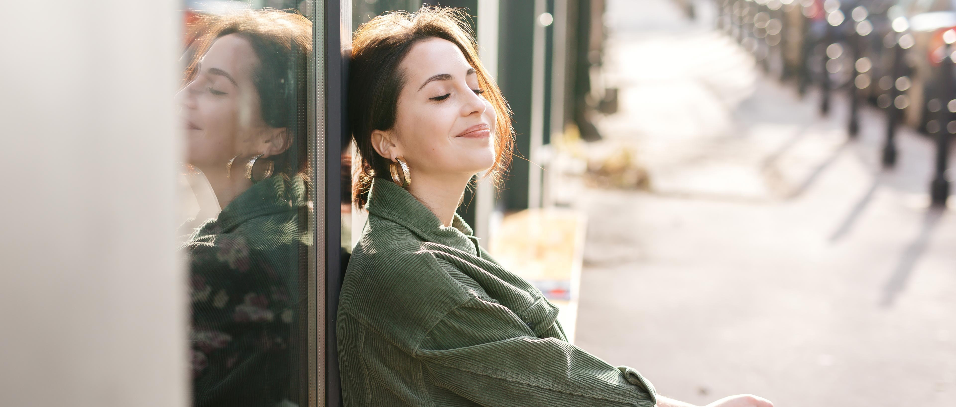 Woman sitting outside office smiling A woman sitting outside her office smiling