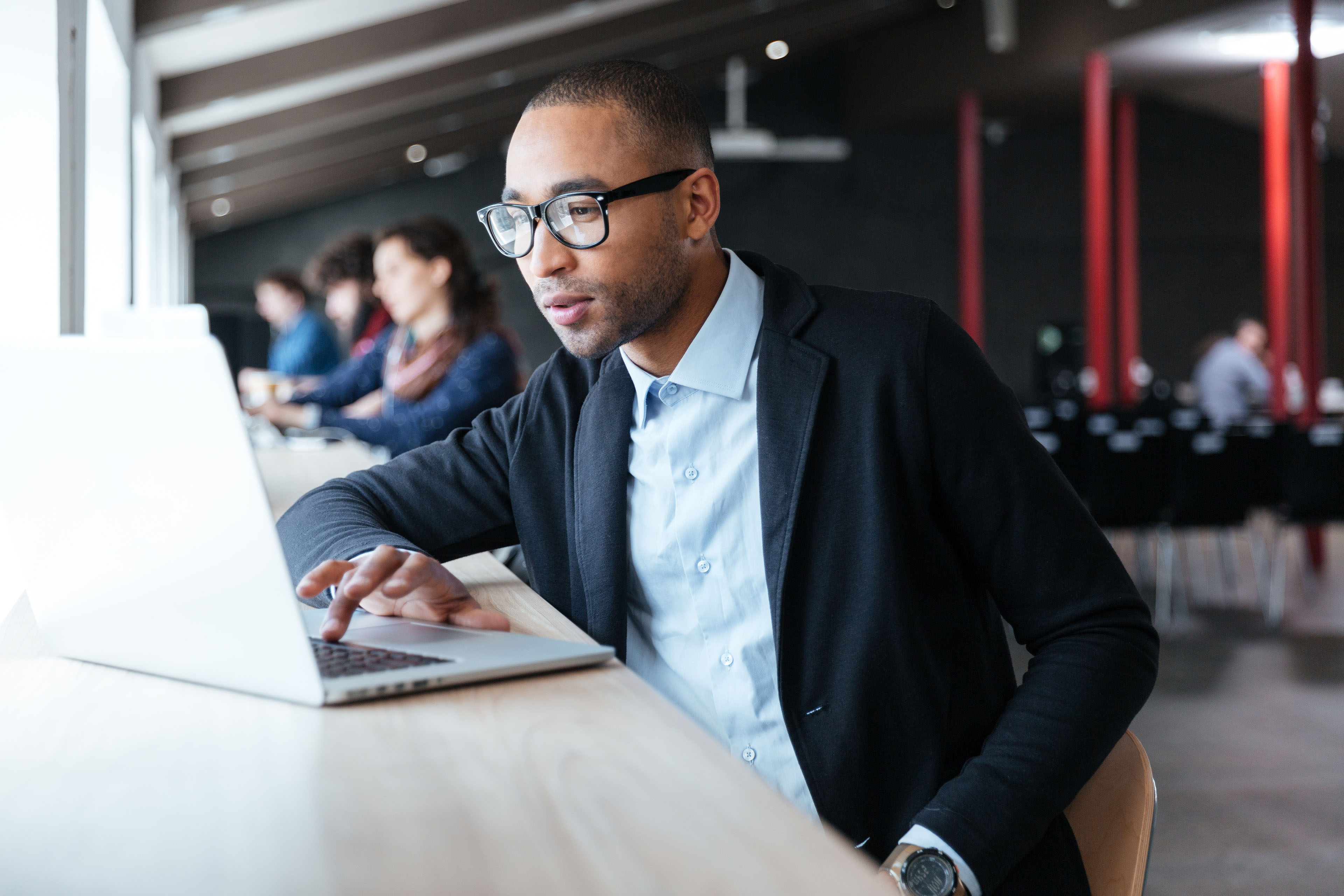 EY Talent communities Portrait of a businessman working with laptop